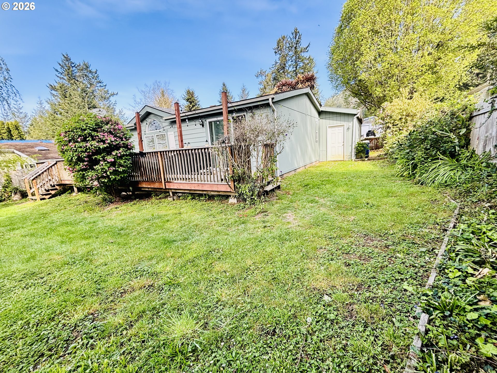 98190 Gavin Lane Brookings, OR 97415 - Photo 5 of 37 a view of a house with a yard and sitting area