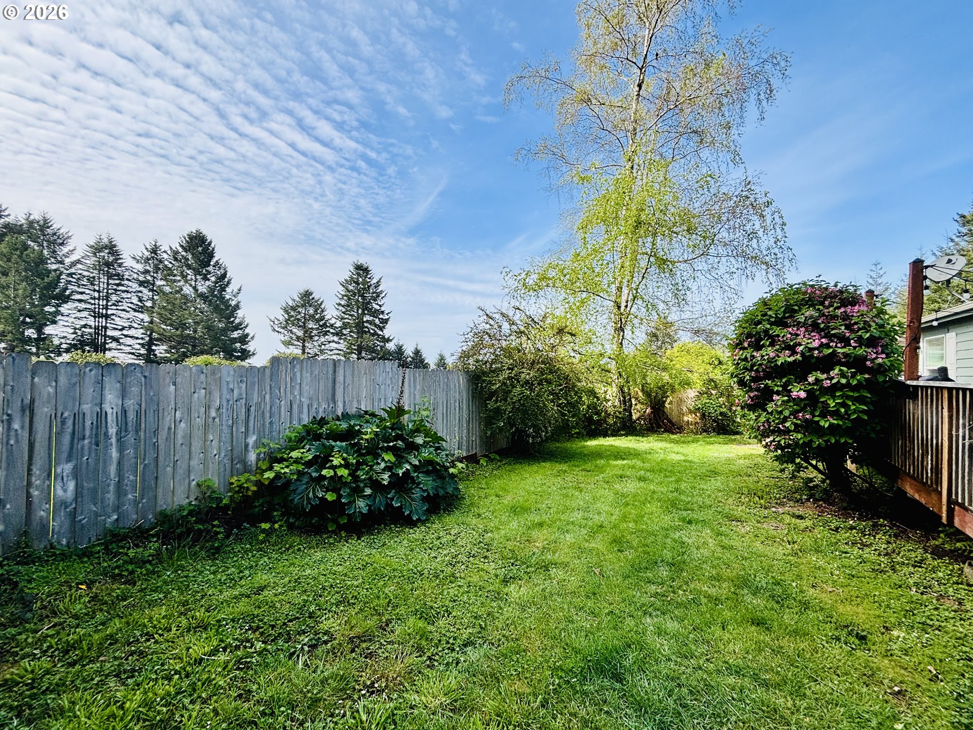 98190 Gavin Lane Brookings, OR 97415 - Photo 6 of 37 a view of a garden with a fountain