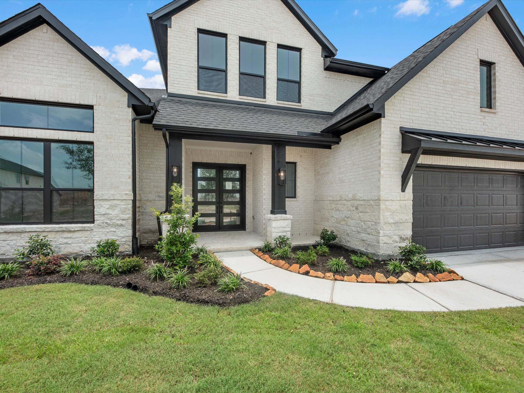 8915 Acropolis Lane Manvel, TX 77578 - Photo 2 of 32 a front view of a house with a yard