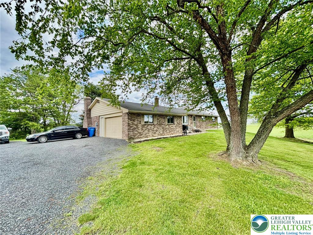 8813 Bluejay Road Kempton, PA 19529 - Photo 20 of 23 This charming home features a brick exterior and a spacious yard, perfect for outdoor enjoyment.