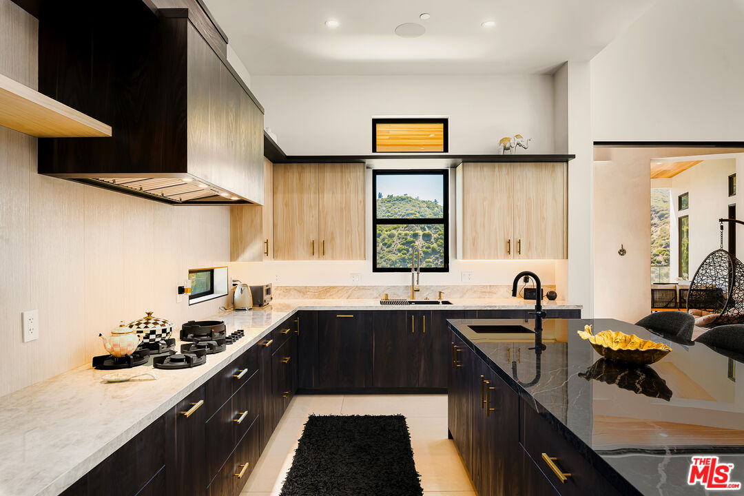1367 Casiano Road Los Angeles, CA 90049 - Photo 11 of 26 a kitchen with a sink a stove and cabinets