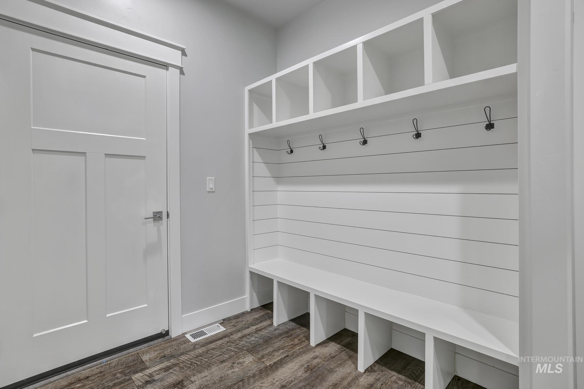 1937 Tamarack Loop Twin Falls, ID 83301 - Photo 29 of 50 Mudroom featuring shiplap-style built-in storage with cubbies, an integrated bench, and coat hooks