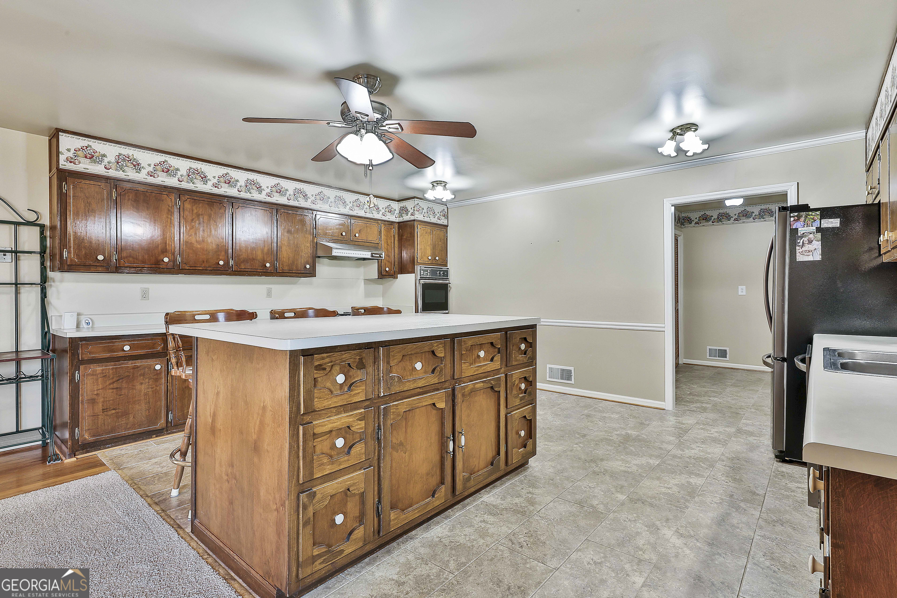 910 Line Creek Road Senoia, GA 30276 - Photo 17 of 56 a kitchen with stainless steel appliances granite countertop a sink a stove and cabinets