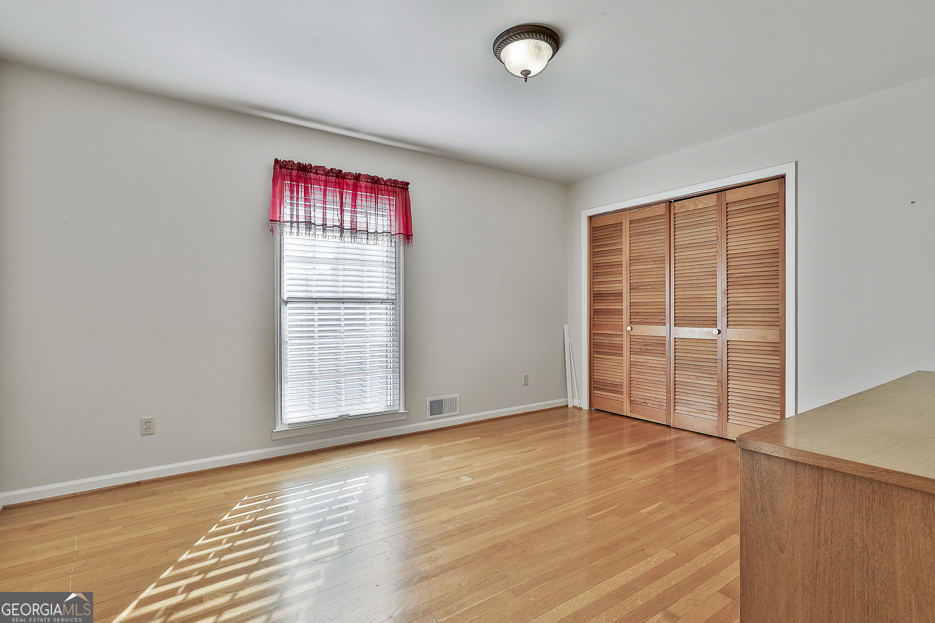 910 Line Creek Road Senoia, GA 30276 - Photo 30 of 56 an empty room with wooden floor and windows