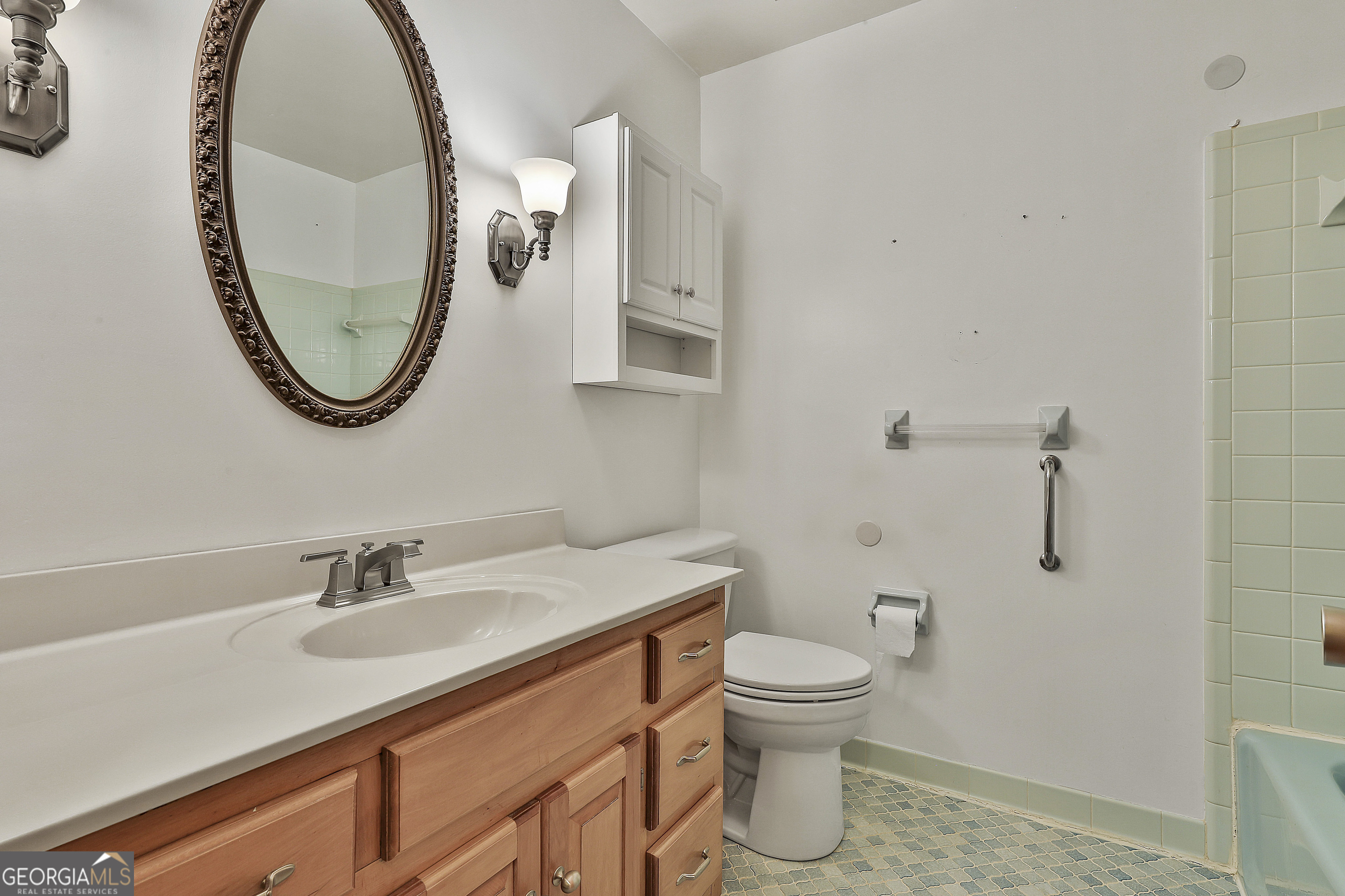 910 Line Creek Road Senoia, GA 30276 - Photo 31 of 56 a bathroom with a toilet sink and mirror