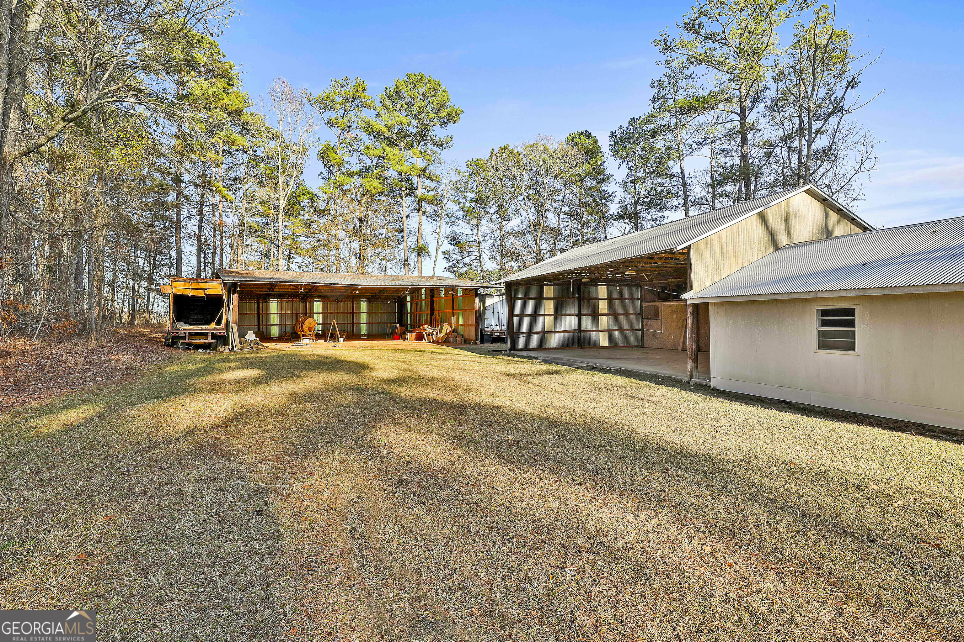 910 Line Creek Road Senoia, GA 30276 - Photo 8 of 56 a front view of a house with a yard and garage