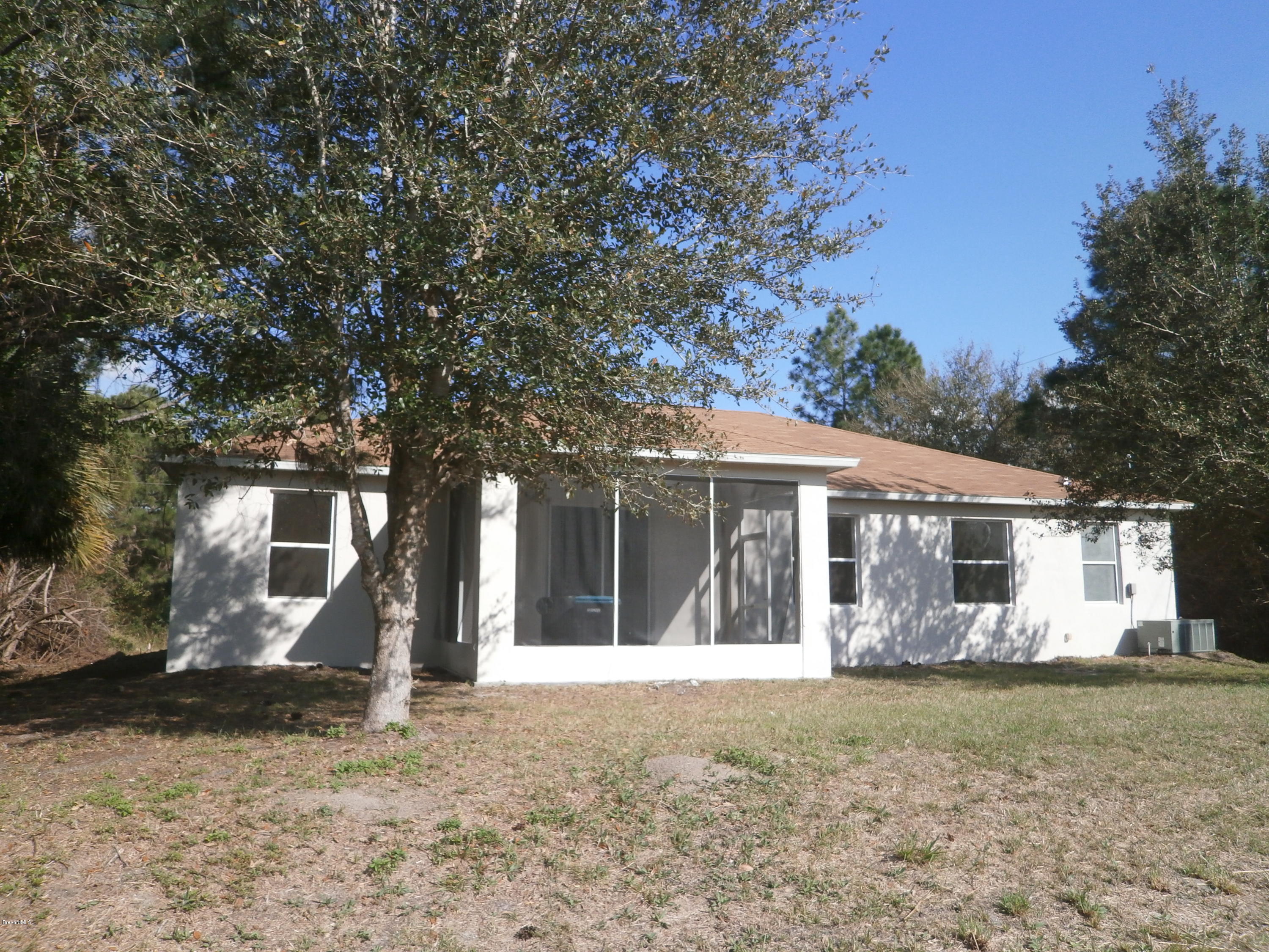 2784 Digby Road Southeast Palm Bay, FL 32909 - Photo 2 of 19 a front view of a house with garden