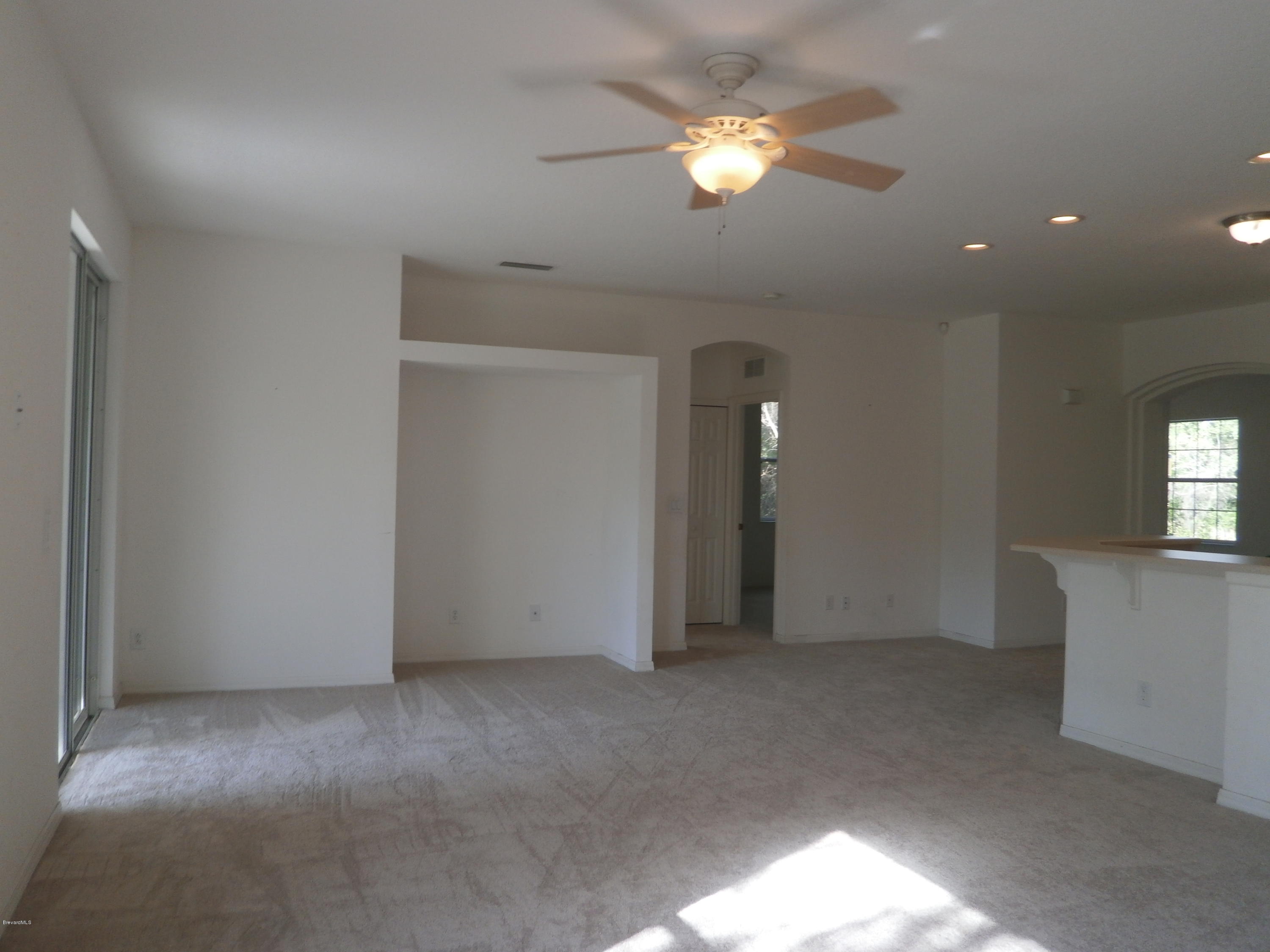 2784 Digby Road Southeast Palm Bay, FL 32909 - Photo 18 of 19 a view of an empty room with a chandelier fan
