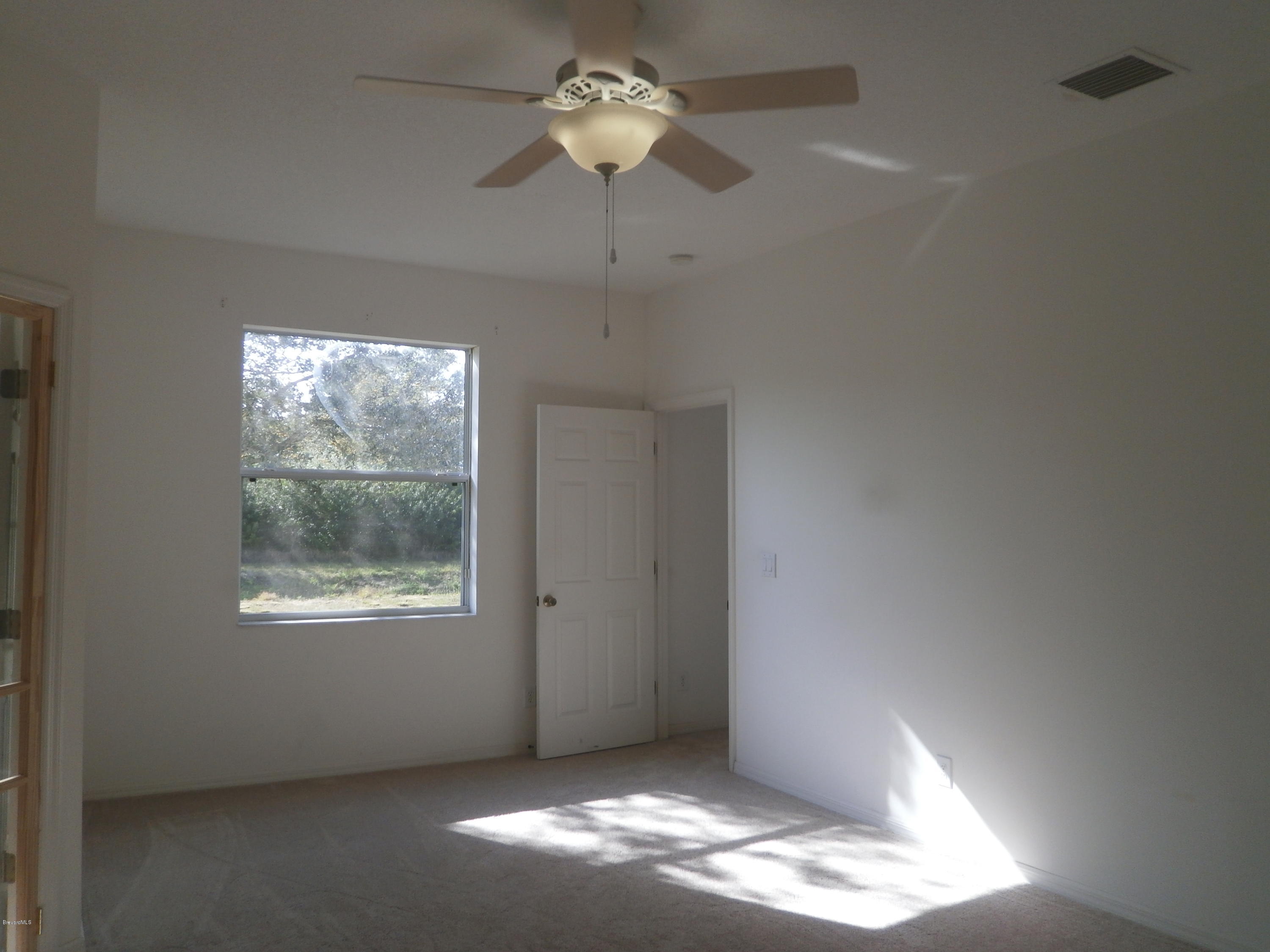 2784 Digby Road Southeast Palm Bay, FL 32909 - Photo 19 of 19 a view of an empty room with a window