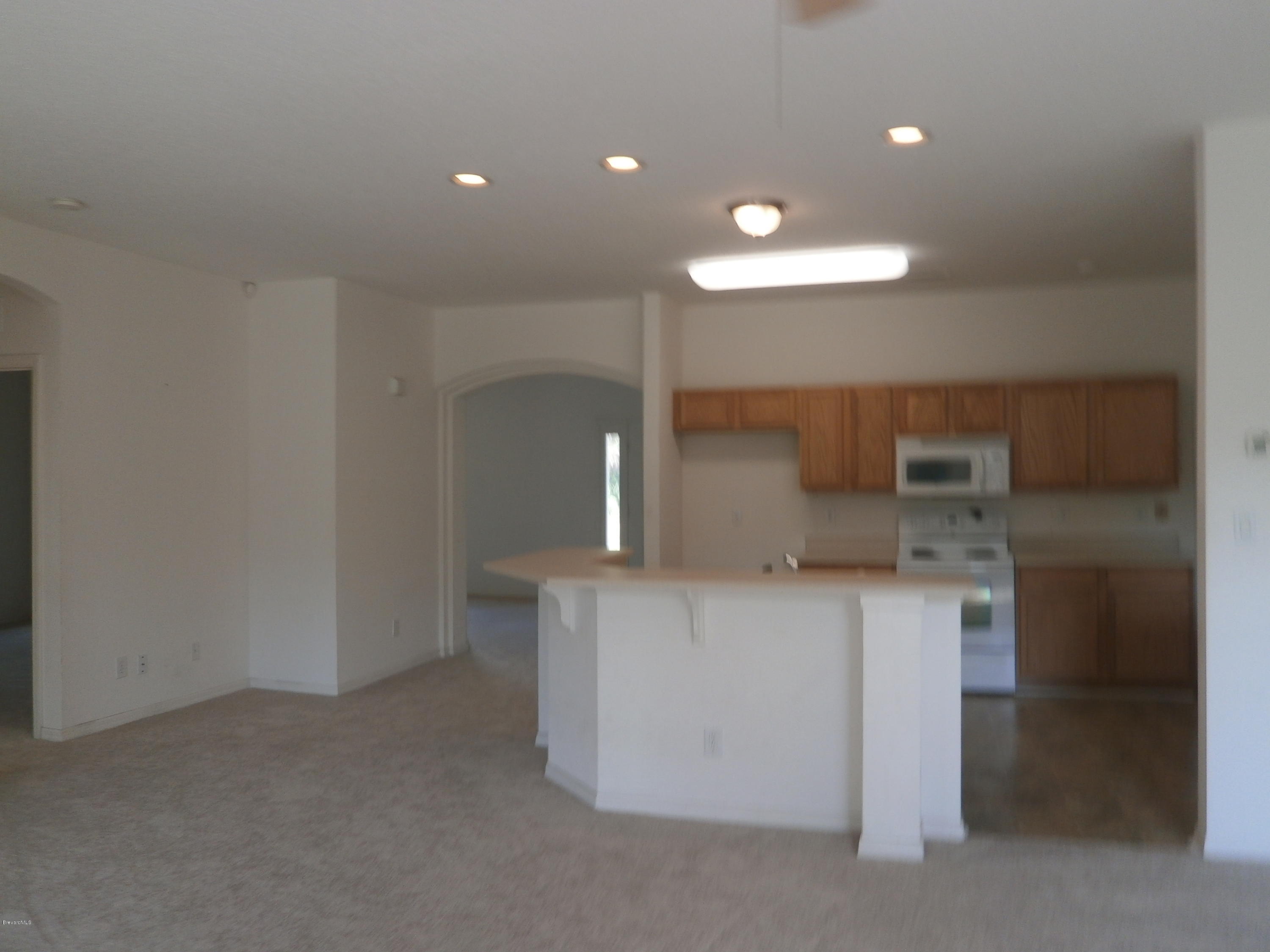 2784 Digby Road Southeast Palm Bay, FL 32909 - Photo 3 of 19 a kitchen with stainless steel appliances a sink and a refrigerator