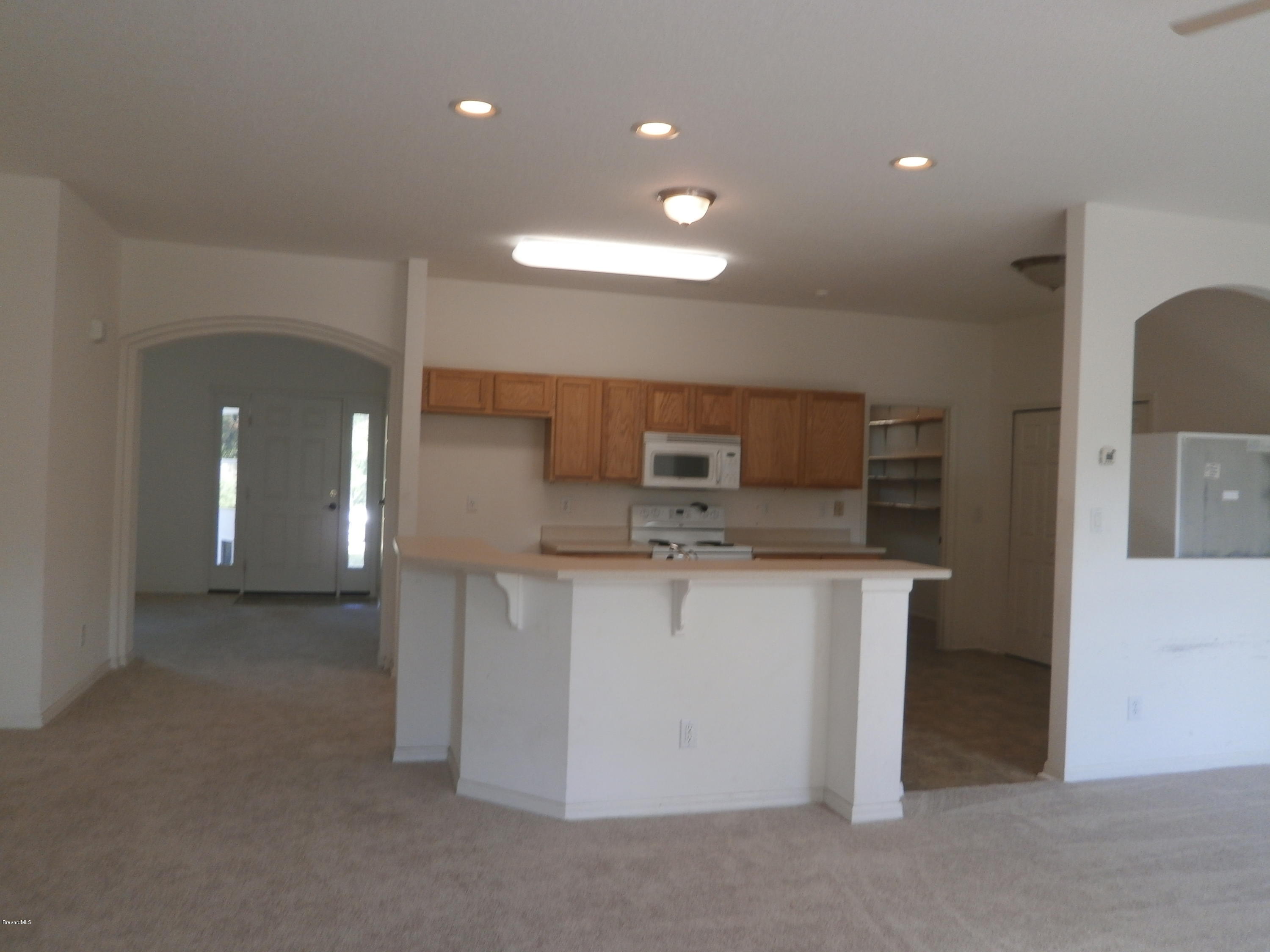 2784 Digby Road Southeast Palm Bay, FL 32909 - Photo 6 of 19 a kitchen with stainless steel appliances granite countertop a sink and stove