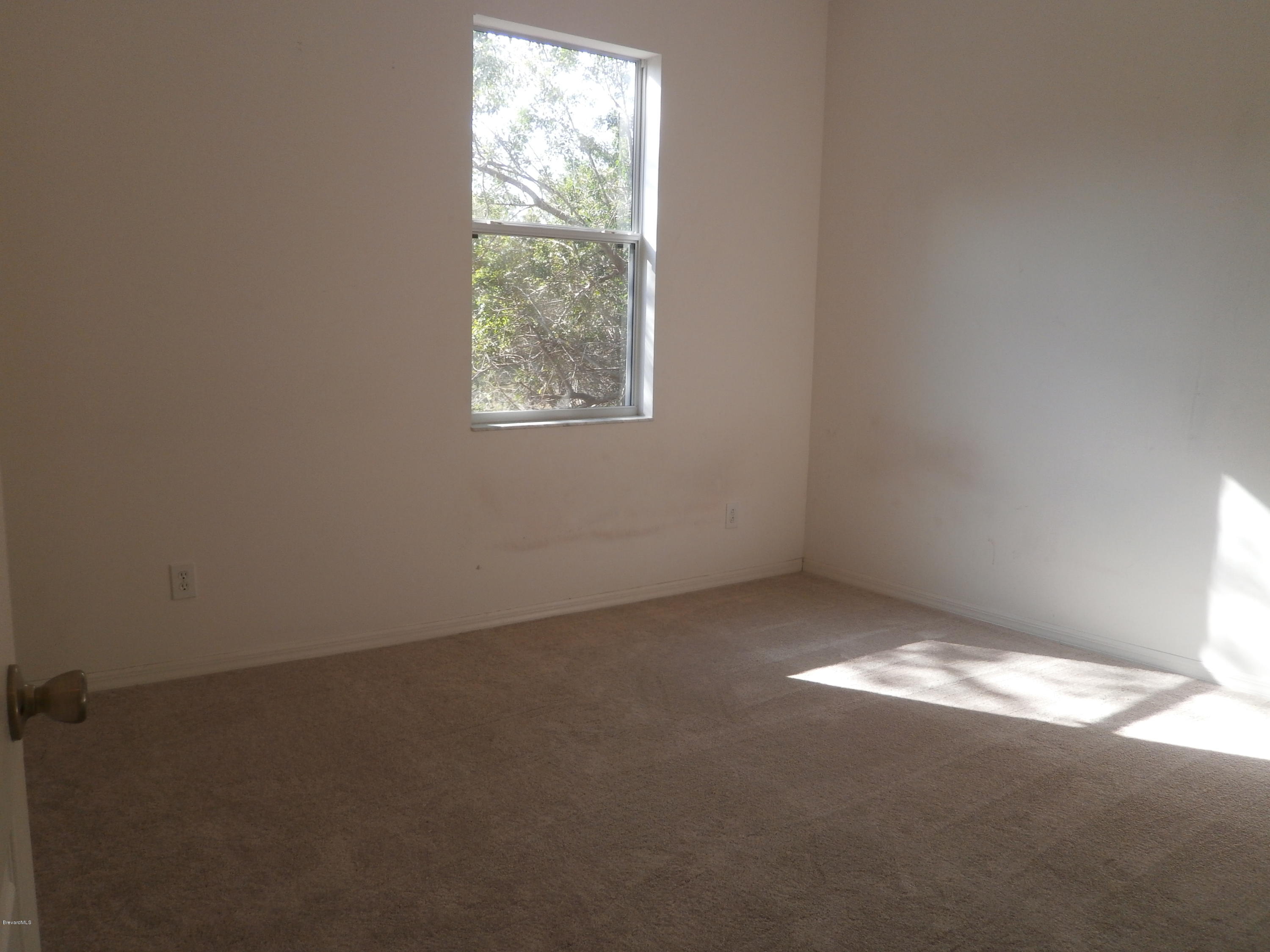 2784 Digby Road Southeast Palm Bay, FL 32909 - Photo 7 of 19 an empty room with a window