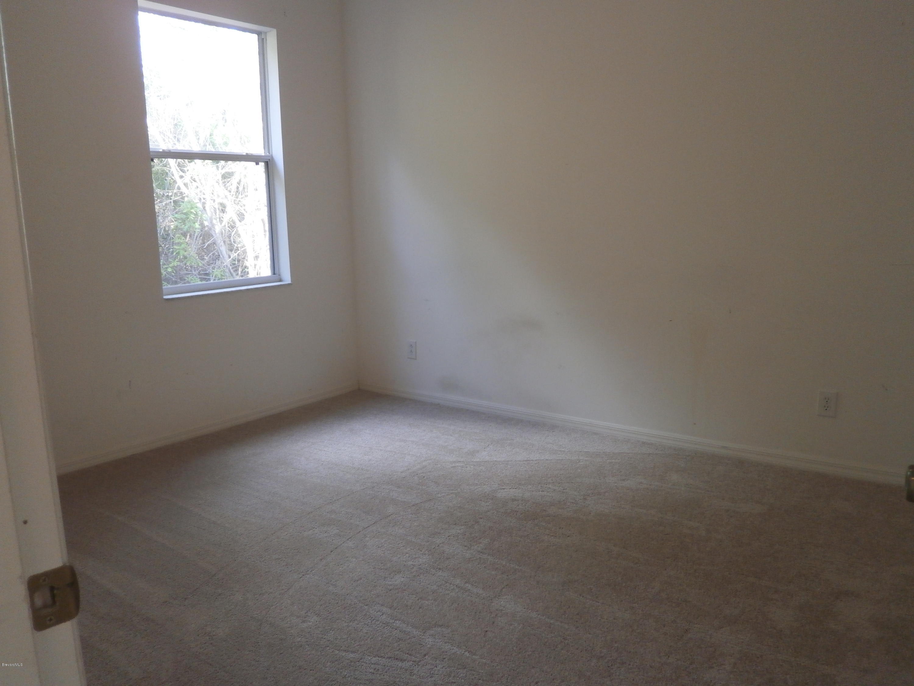 2784 Digby Road Southeast Palm Bay, FL 32909 - Photo 8 of 19 an empty room with a window