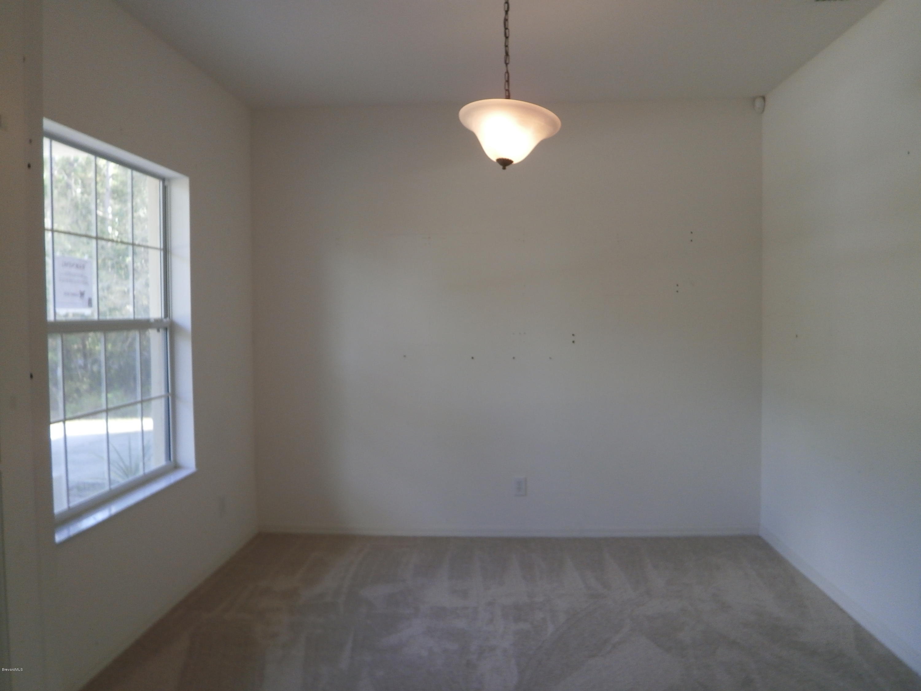 2784 Digby Road Southeast Palm Bay, FL 32909 - Photo 9 of 19 an empty room with window