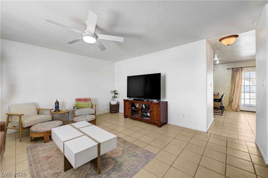 1272 Liston Avenue Logandale, NV 89021 - Photo 8 of 61 Relax in this comfortable living space with practical tile flooring and an integrated ceiling fan.