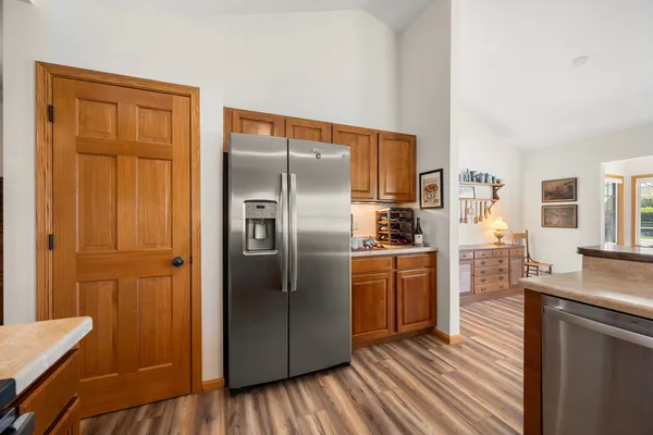 a kitchen with stainless steel appliances granite countertop a refrigerator and a stove top oven