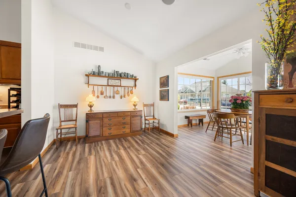 a dining room with furniture window and wooden floor