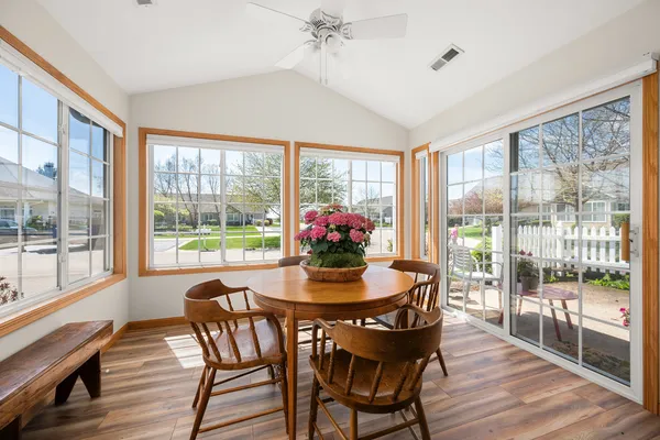 a dining room with furniture window and wooden floor