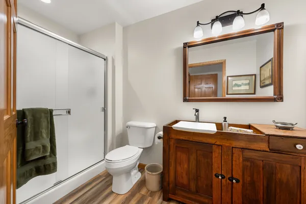 a bathroom with a toilet sink and mirror