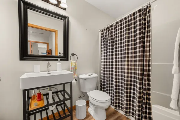 a bathroom with a toilet a sink and a mirror