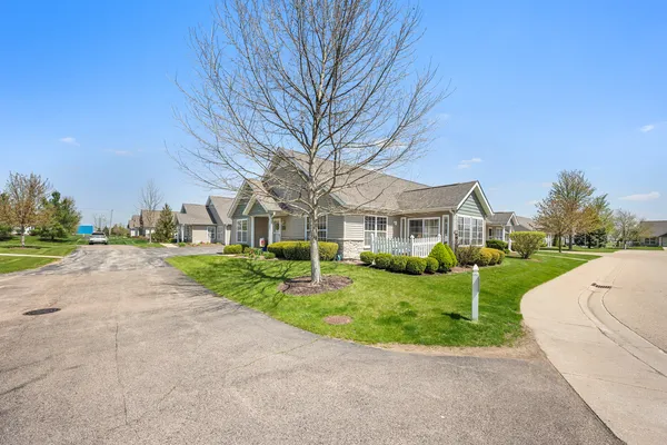 a view of house with yard and green space