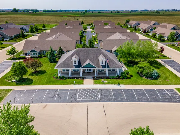 an aerial view of a house with a garden and lake view