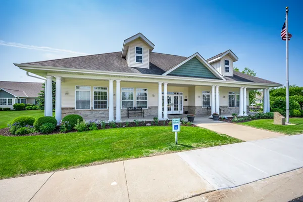 a front view of a house with yard and green space