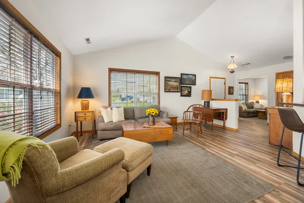 a living room with furniture and large windows