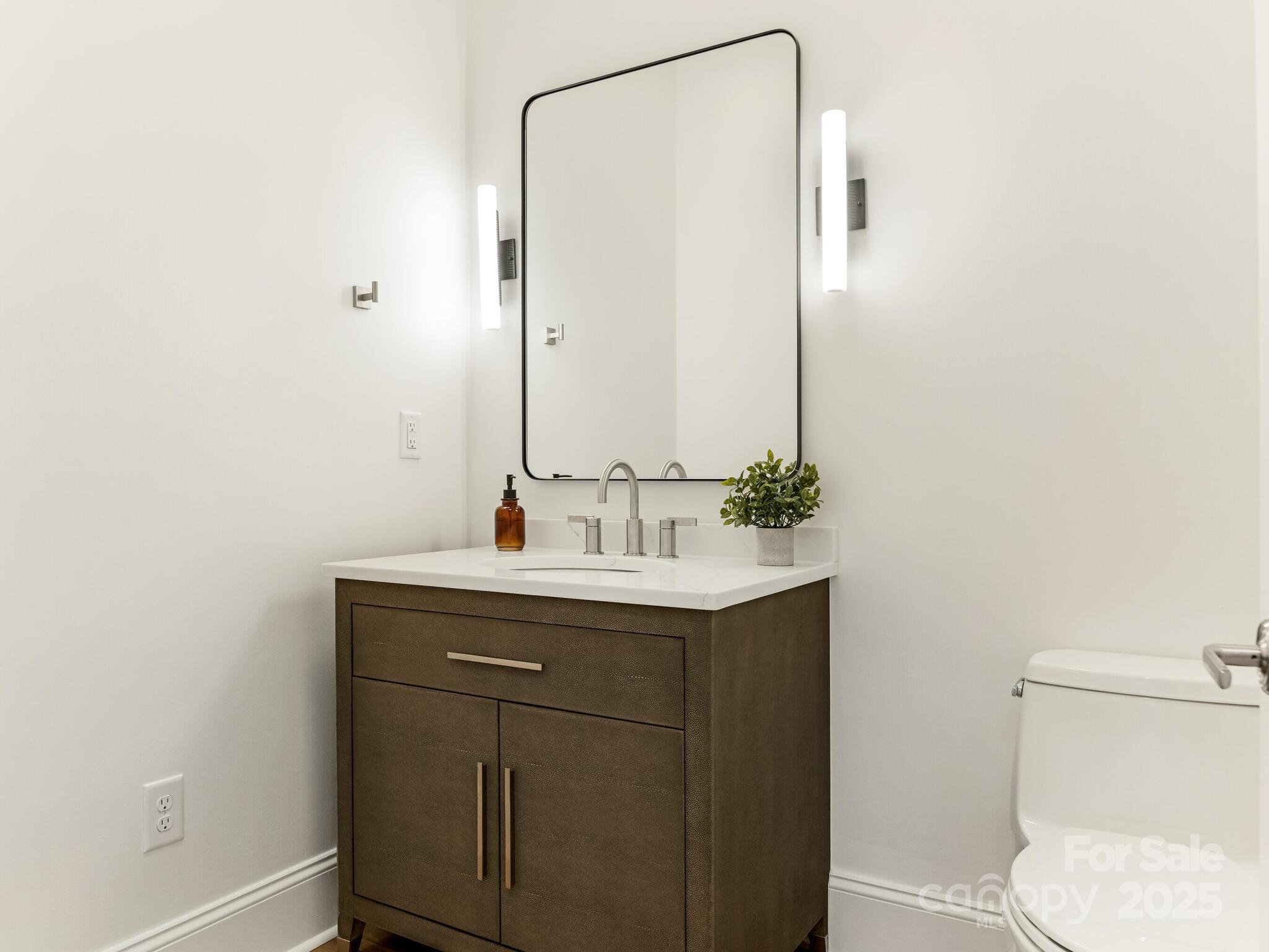 2823 Providence Road, Unit 152 Charlotte, NC 28211 - Photo 11 of 41 a bathroom with a sink toilet and vanity
