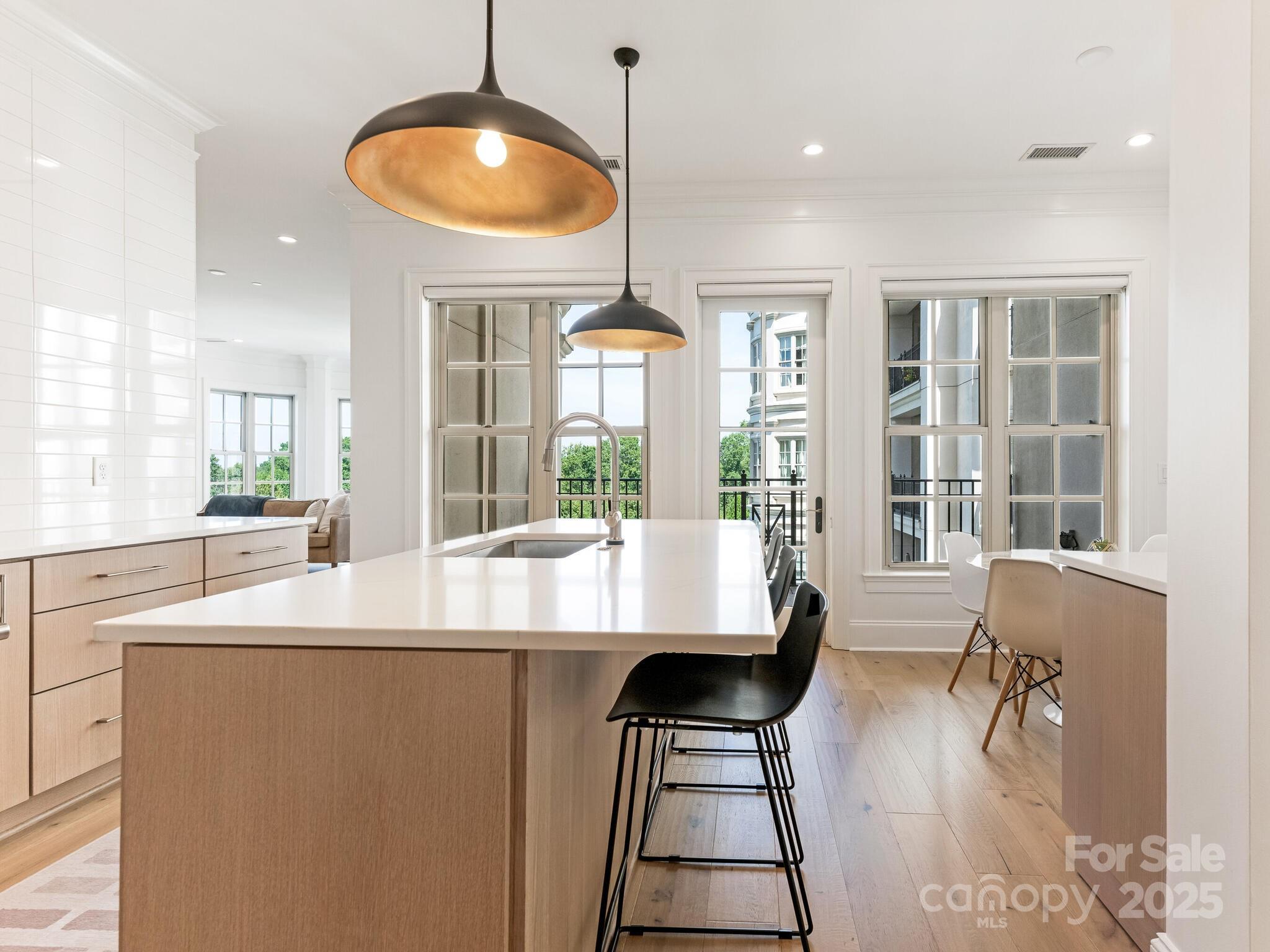 2823 Providence Road, Unit 152 Charlotte, NC 28211 - Photo 16 of 41 a dining hall with stainless steel appliances granite countertop a dining table chairs and a chandelier