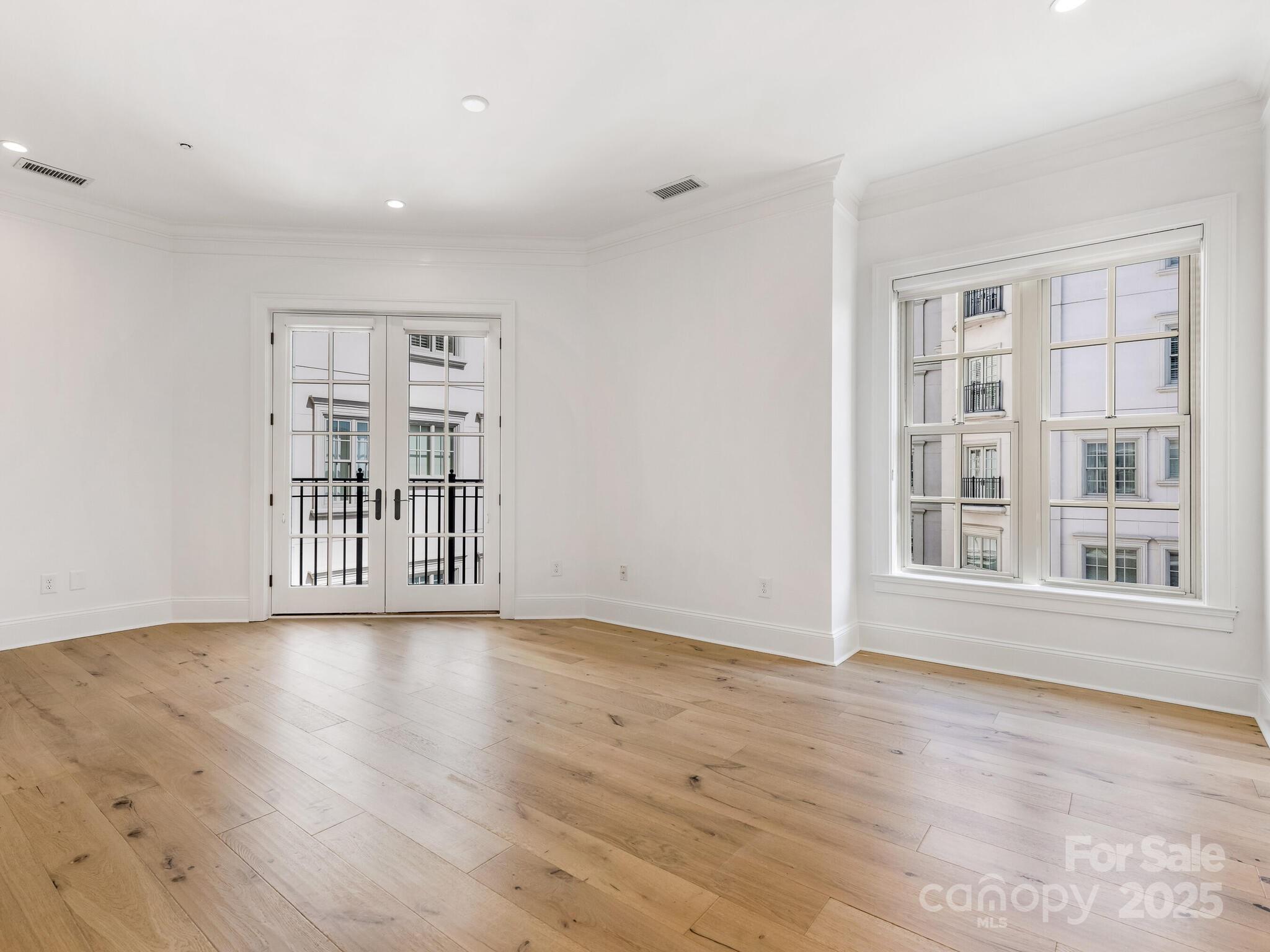 2823 Providence Road, Unit 152 Charlotte, NC 28211 - Photo 21 of 41 a view of an empty room with a window and wooden floor