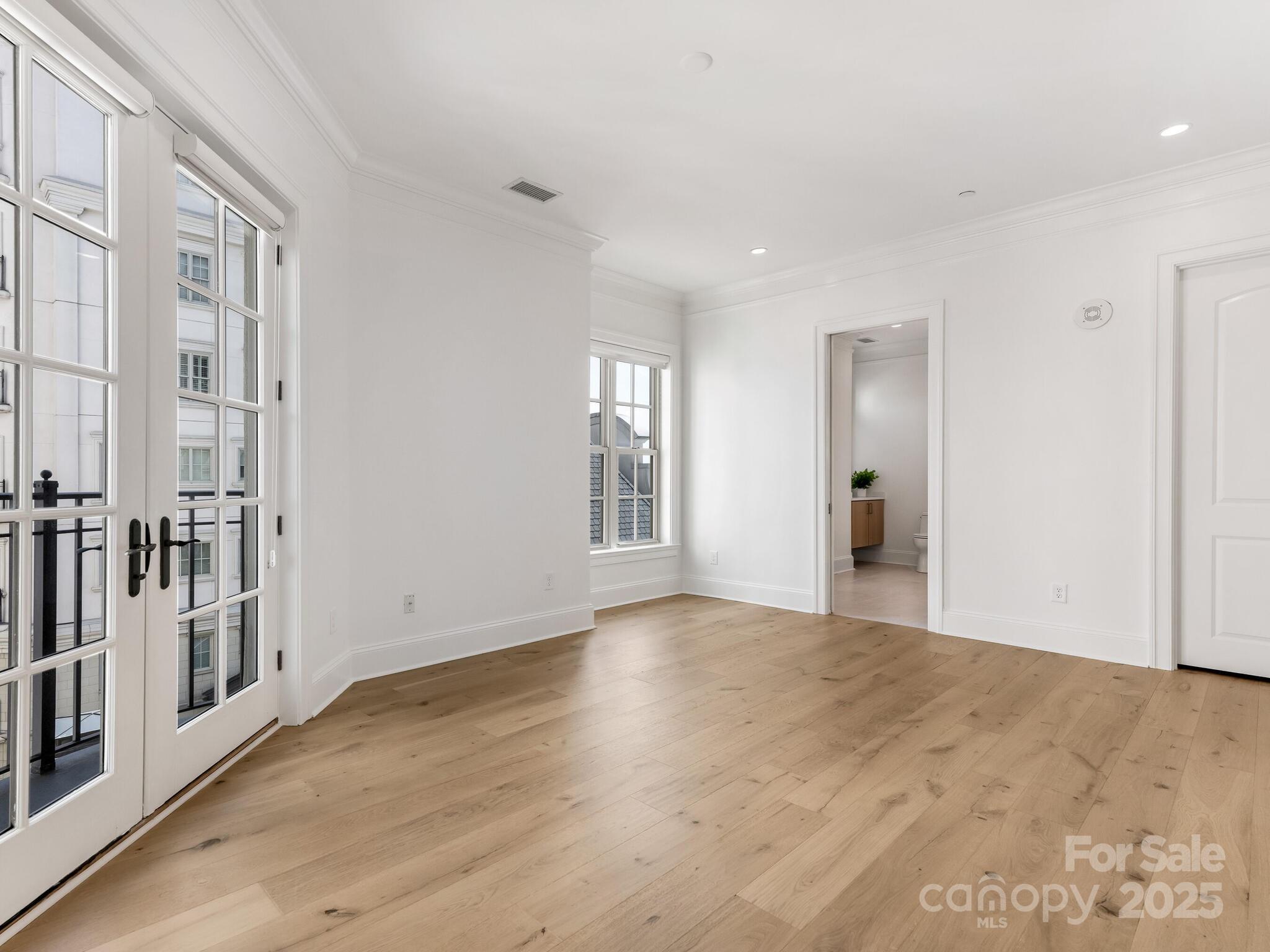 2823 Providence Road, Unit 152 Charlotte, NC 28211 - Photo 22 of 41 a view of an empty room with wooden floor and a window