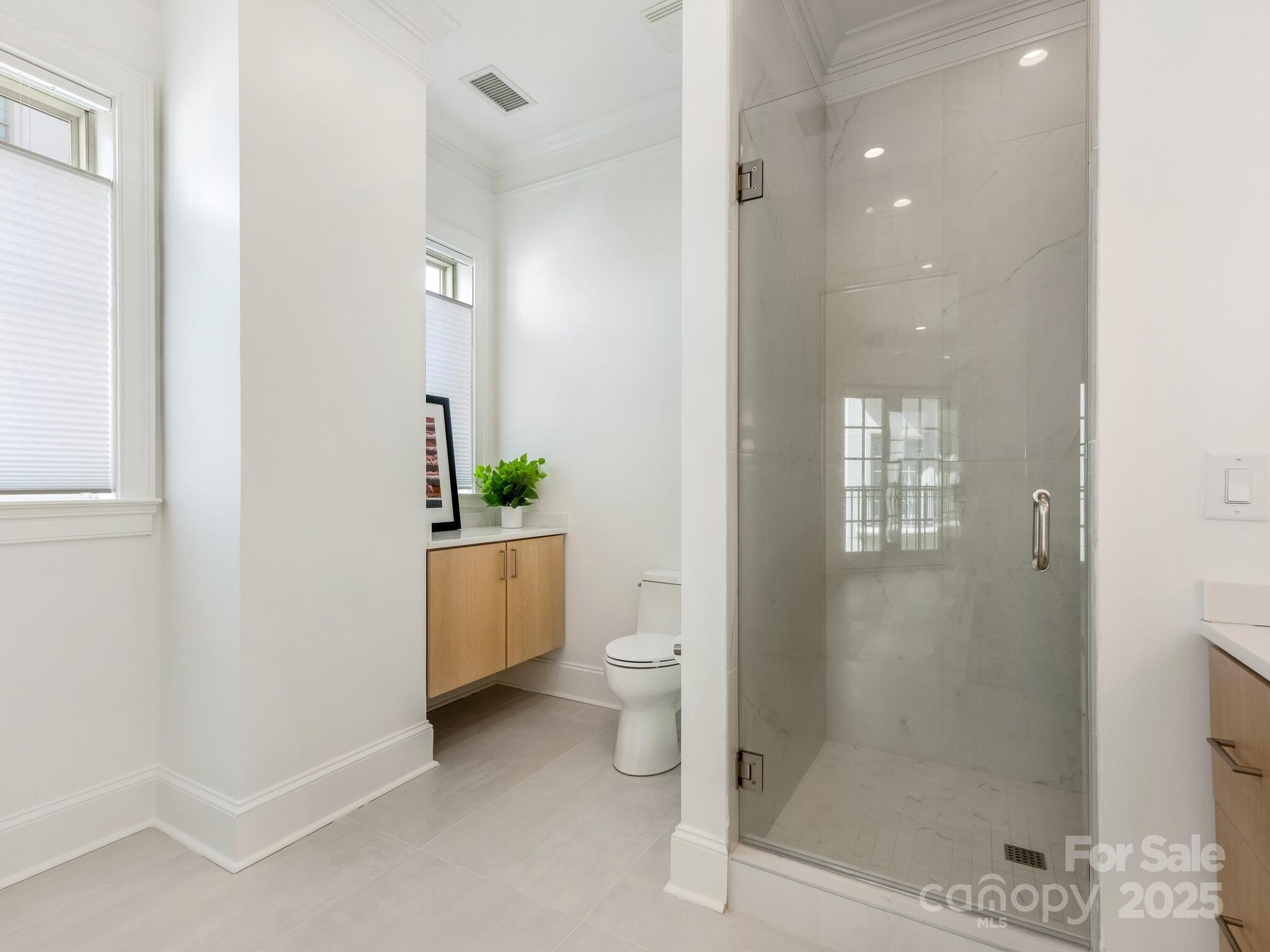 2823 Providence Road, Unit 152 Charlotte, NC 28211 - Photo 24 of 41 a bathroom with a shower a toilet and a sink