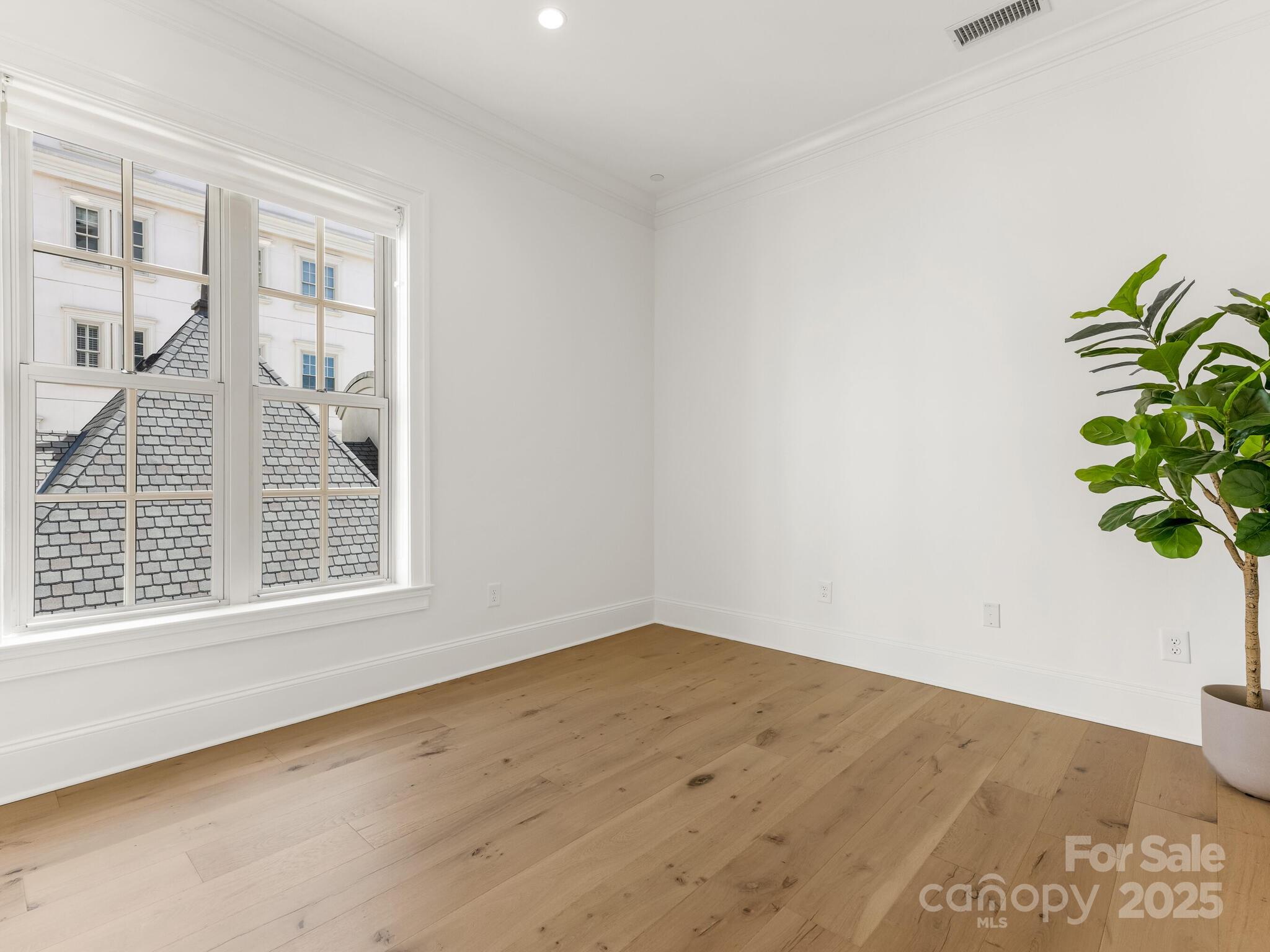 2823 Providence Road, Unit 152 Charlotte, NC 28211 - Photo 27 of 41 a view of an empty room with wooden floor and a potted plant