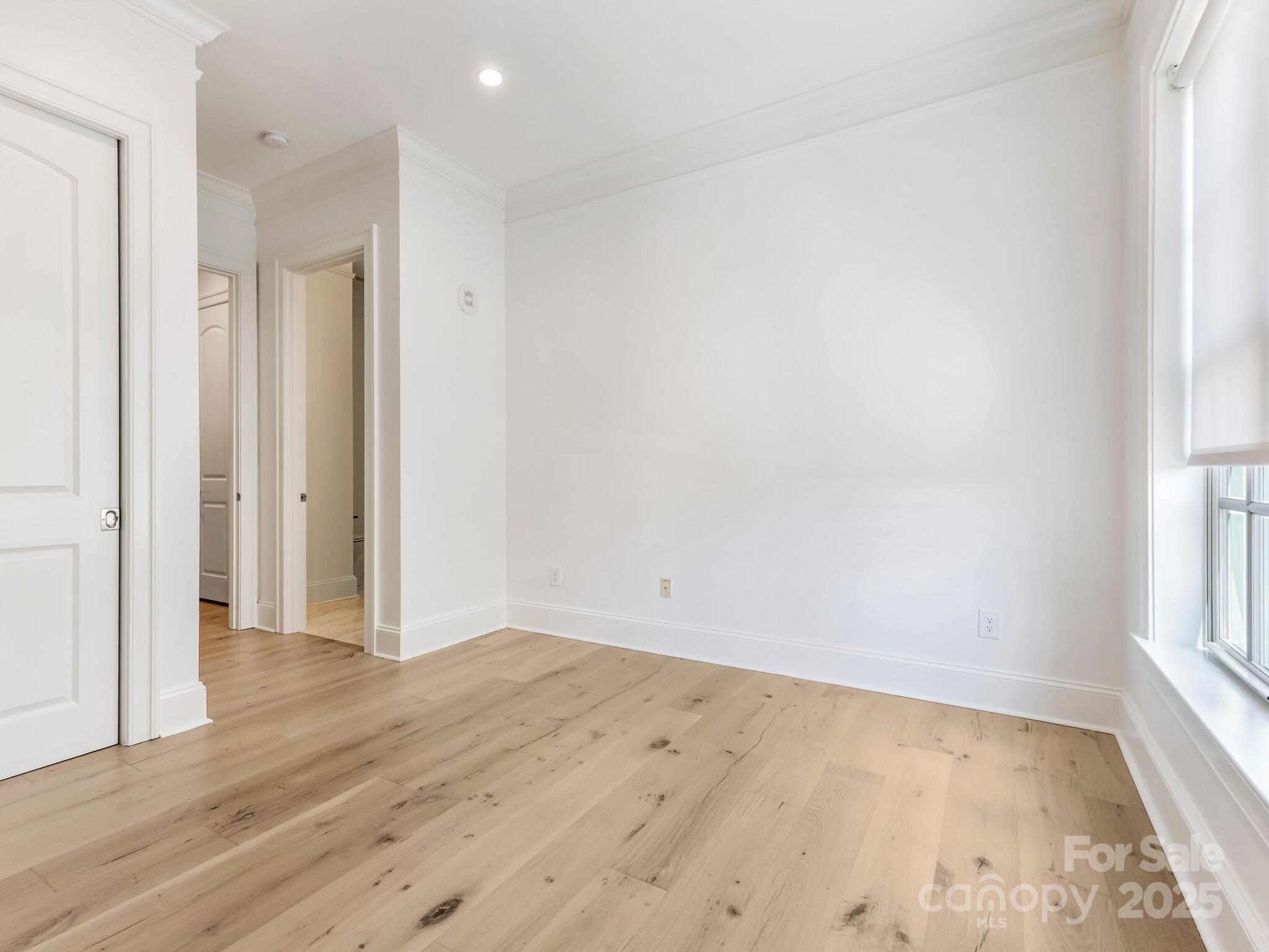 2823 Providence Road, Unit 152 Charlotte, NC 28211 - Photo 28 of 41 an empty room with wooden floor and windows