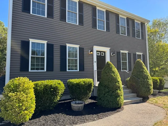 a view of a house with potted plants