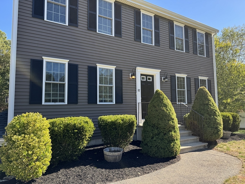 a view of a house with potted plants