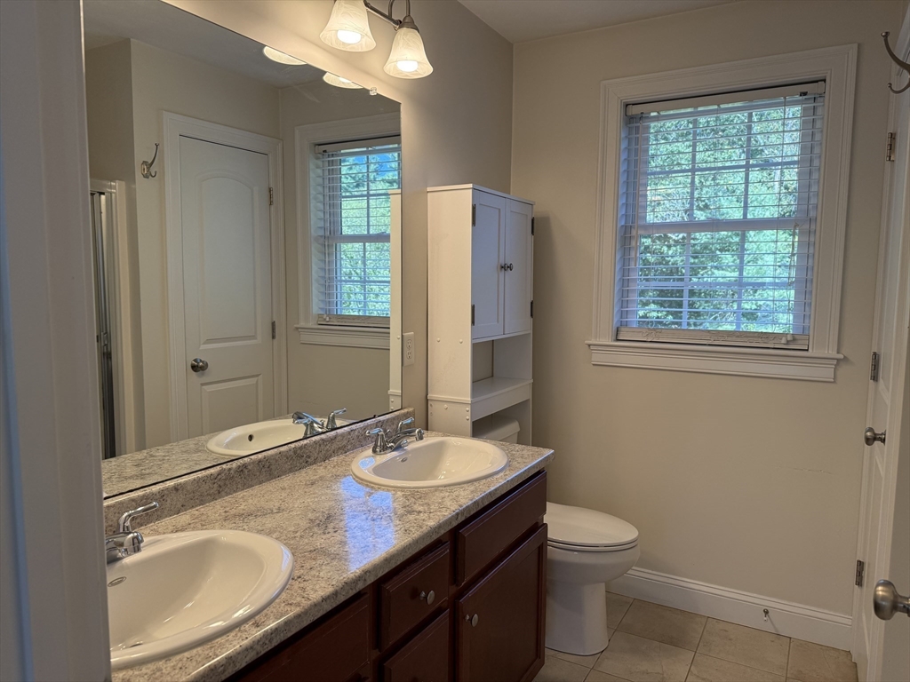 87 Center Street Carver, MA 02330 - Photo 20 of 42 a bathroom with a granite countertop toilet sink and mirror