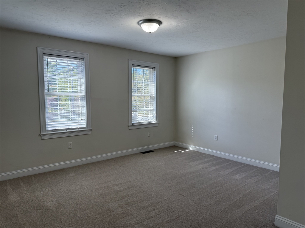 87 Center Street Carver, MA 02330 - Photo 23 of 42 an empty room with windows
