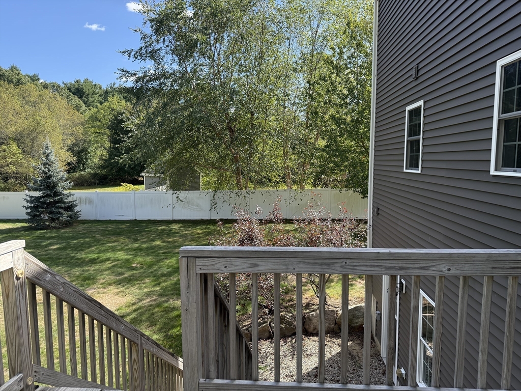 87 Center Street Carver, MA 02330 - Photo 35 of 42 a balcony with trees in front of it