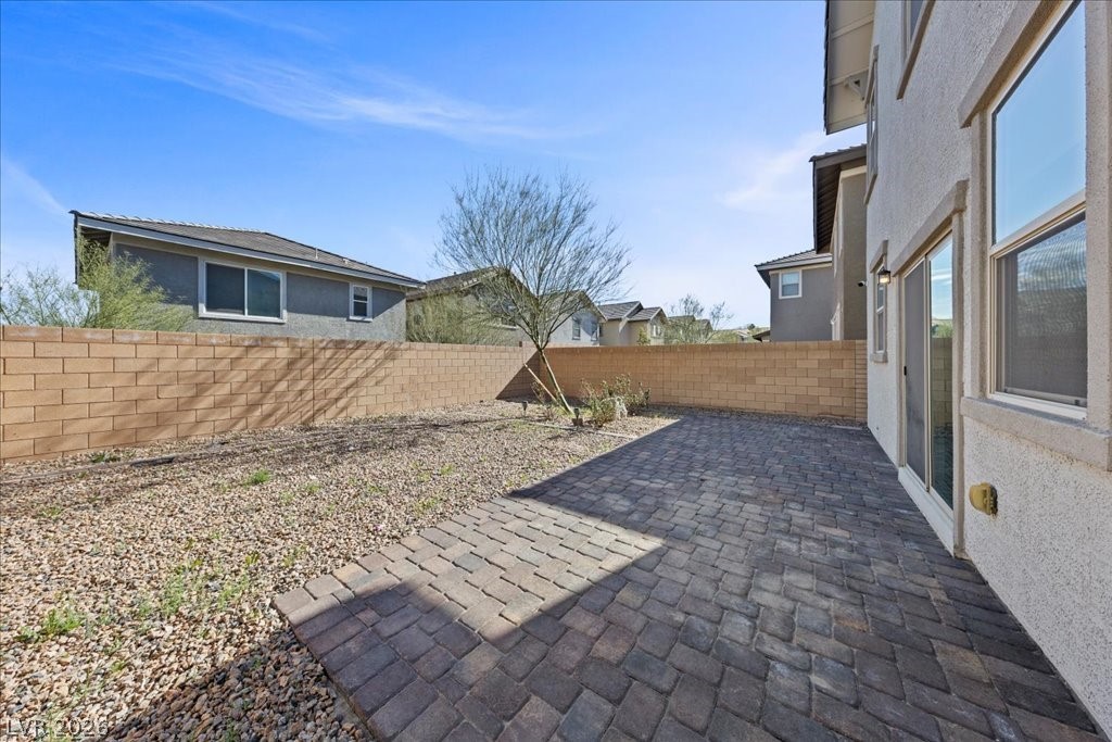 290 Cape Seville Place Henderson, NV 89015 - Photo 33 of 50 Private backyard fully block walled, full length paver patio, complete with a shade tree.