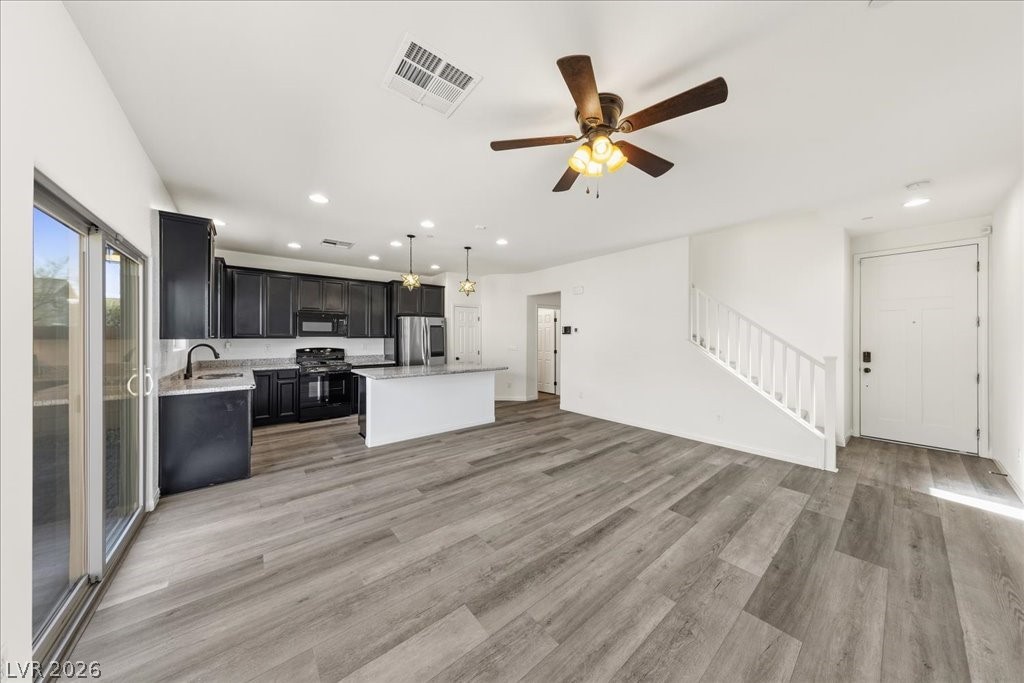 290 Cape Seville Place Henderson, NV 89015 - Photo 7 of 50 Comfortable great room with luxury vinyl plank flooring, ceiling fan and a slider to the back yard.