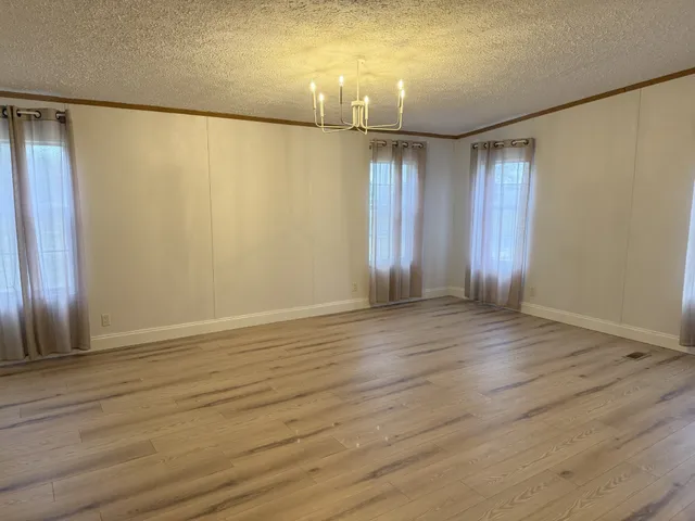 wooden floor in an empty room with a mirror