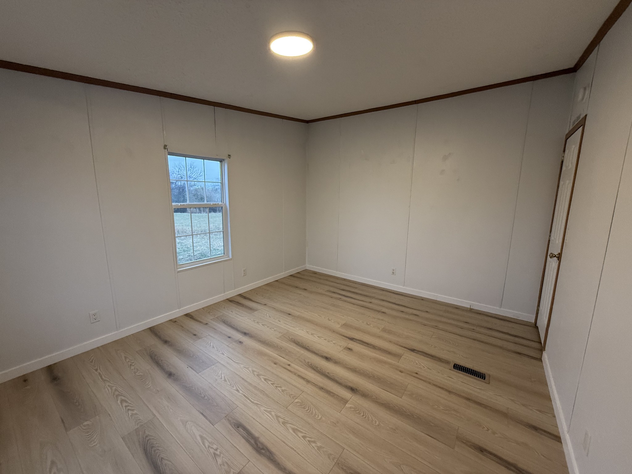 621 Cook Road Portland, TN 37148 - Photo 29 of 55 an empty room with wooden floor and windows