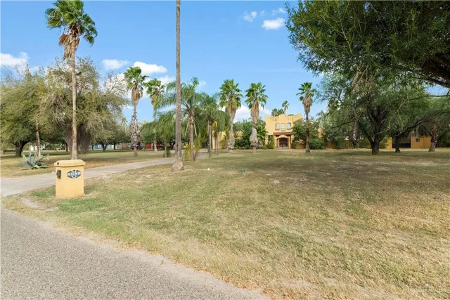 a view of a fountain with a house in the background