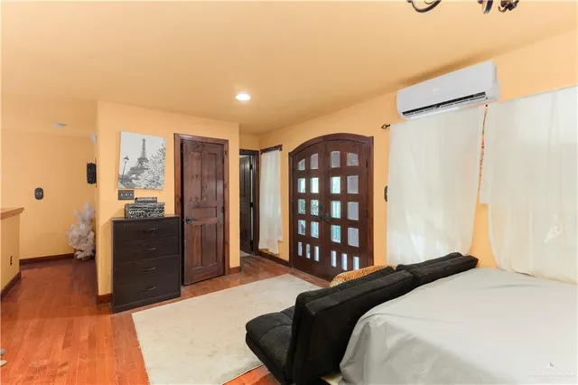 a bedroom with a bed a mirror and lamp