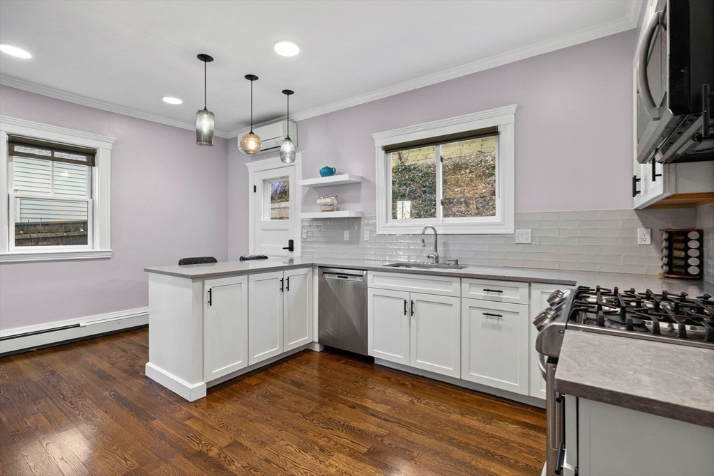 62 Atherton Road, Unit 1 Brookline, MA 02446 - Photo 12 of 24 a kitchen with a sink stove top oven and cabinets