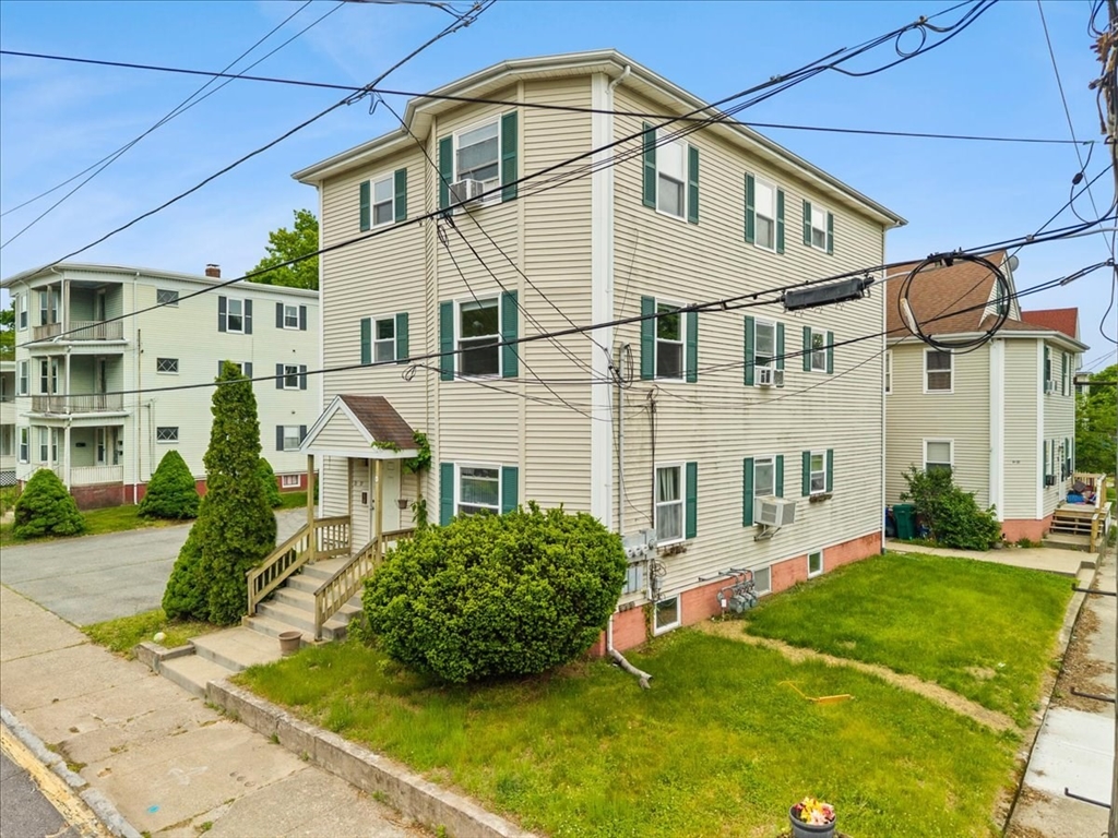 35 Hazel Street, Unit B Attleboro, MA 02703 - Photo 4 of 21 a view of a white house with a big yard and potted plants