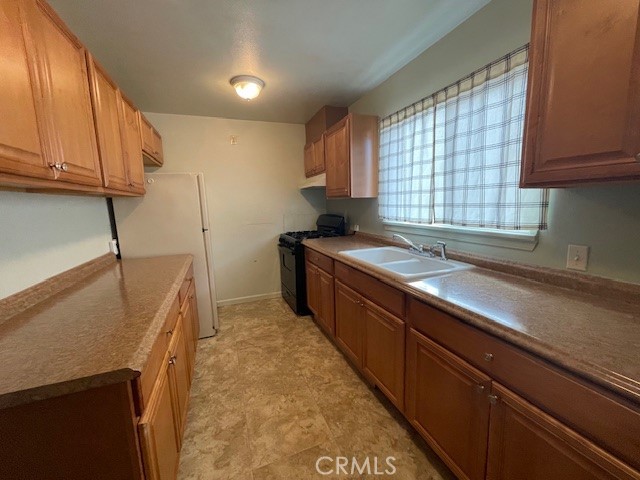 172 North 13th Street Grover Beach, CA 93433 - Photo 14 of 21 a kitchen with stainless steel appliances sink a microwave and cabinets