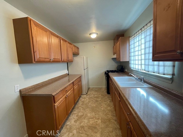 172 North 13th Street Grover Beach, CA 93433 - Photo 15 of 21 a kitchen with sink cabinets and window